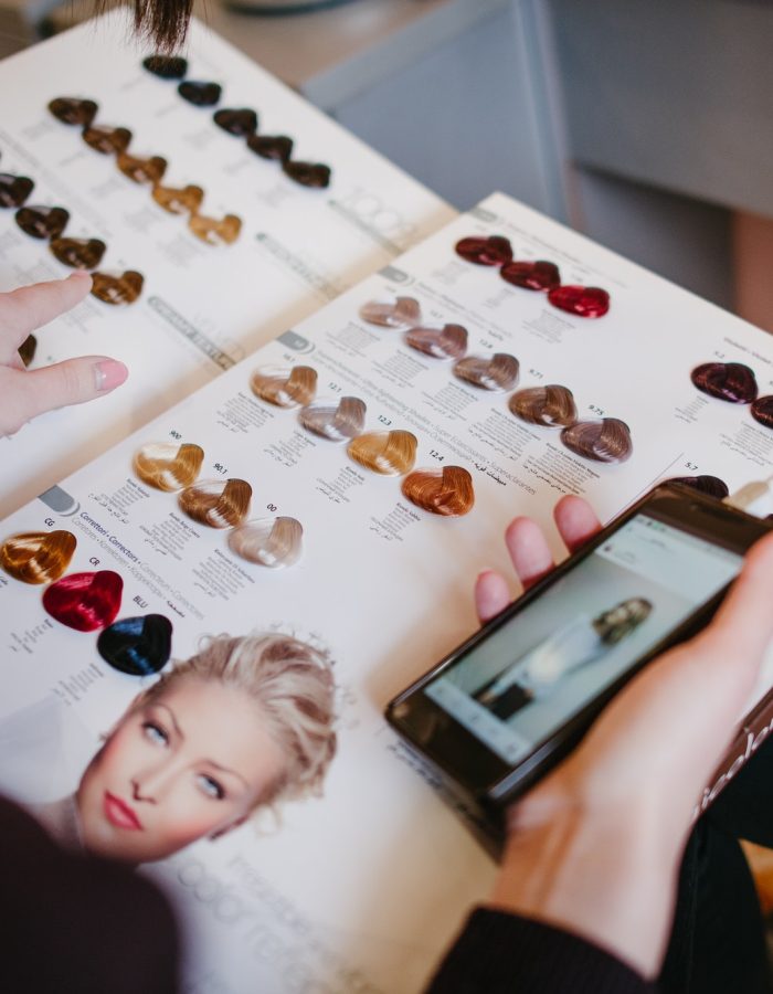 Girl choosing new hair colour from color chart